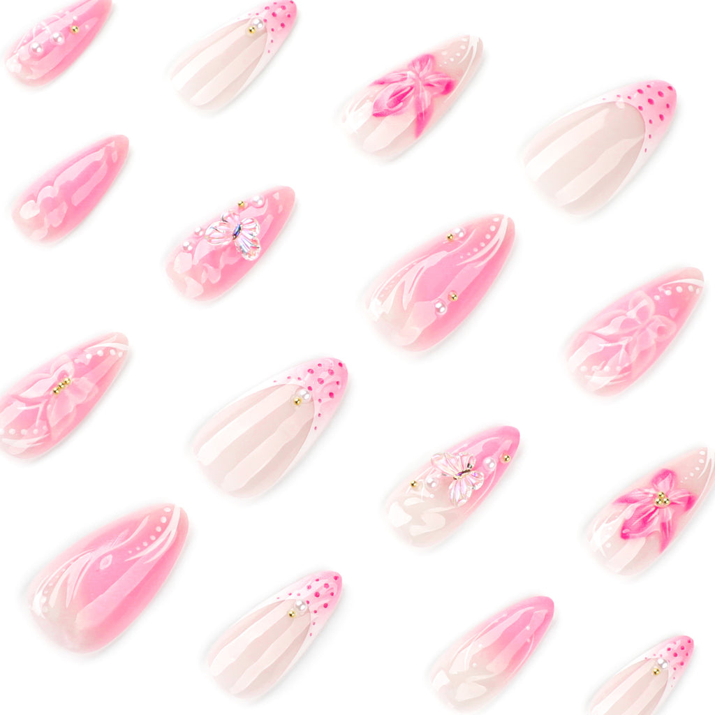 Short almond-shaped nail art with French-style pink color. Wearable artificial nails with 3D flower-shaped nail pieces.